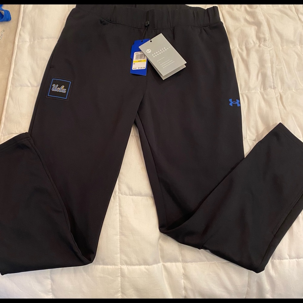UCLA women’s medium loose fit track pant. Zipper at ankle, pockets.